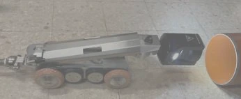 Crawler positioned at the opening of a pipe